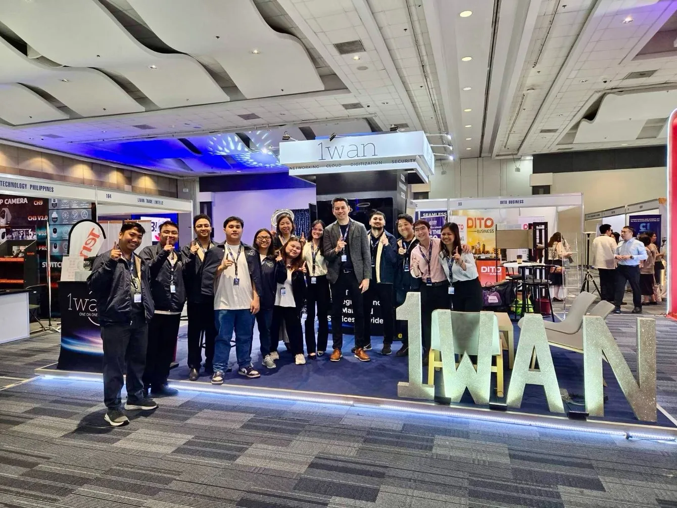 1WAN engineering and business team at an exhibition
